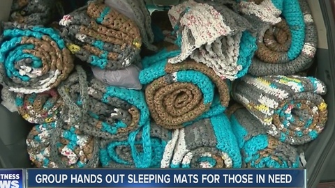 Group hands out sleeping mats for those in need