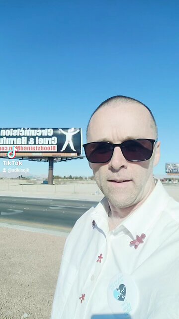 Bloodstained man at Bloodstained Men billboard in Vegas