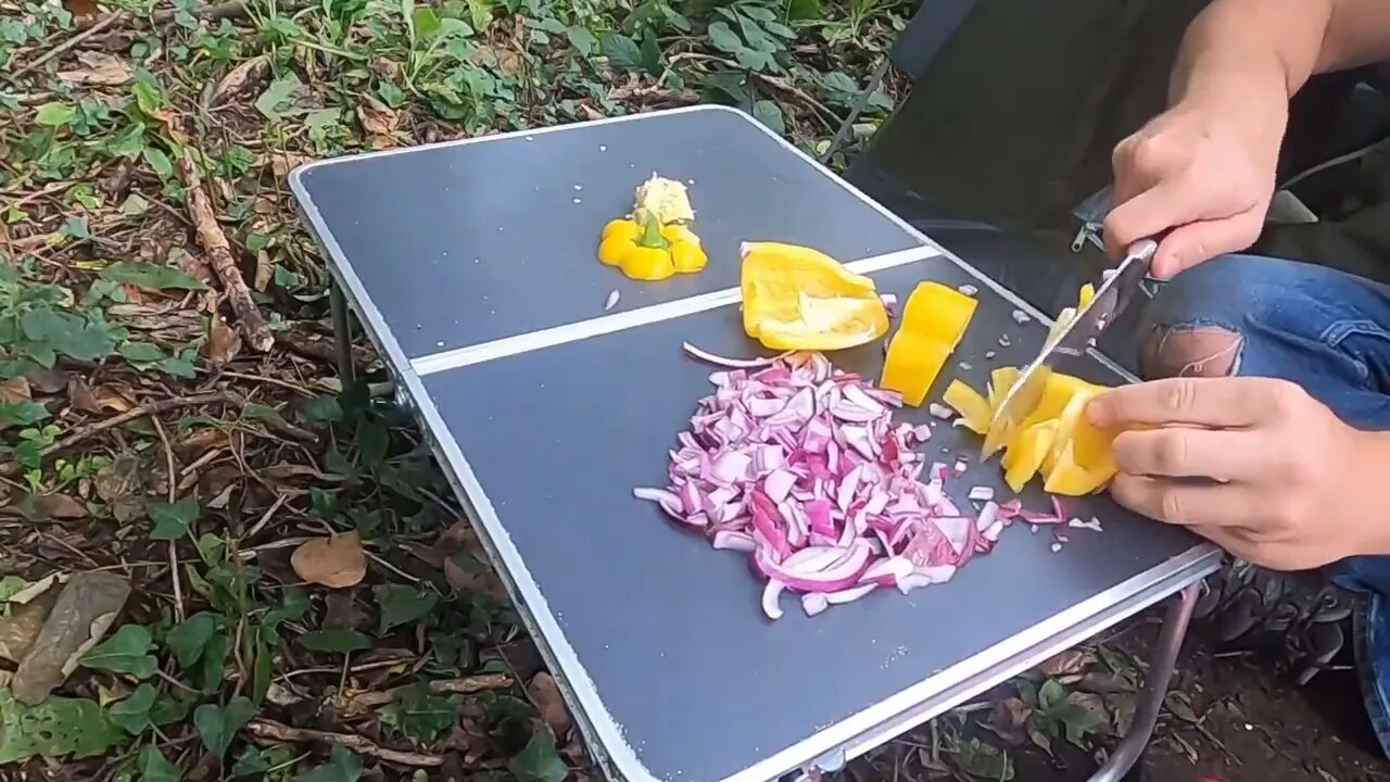 An abundance of camping food in the wilderness.14