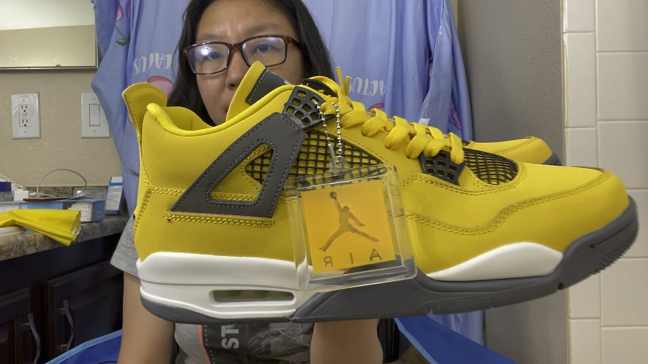 This is a pair FAKE Air Jordan 4 shoes