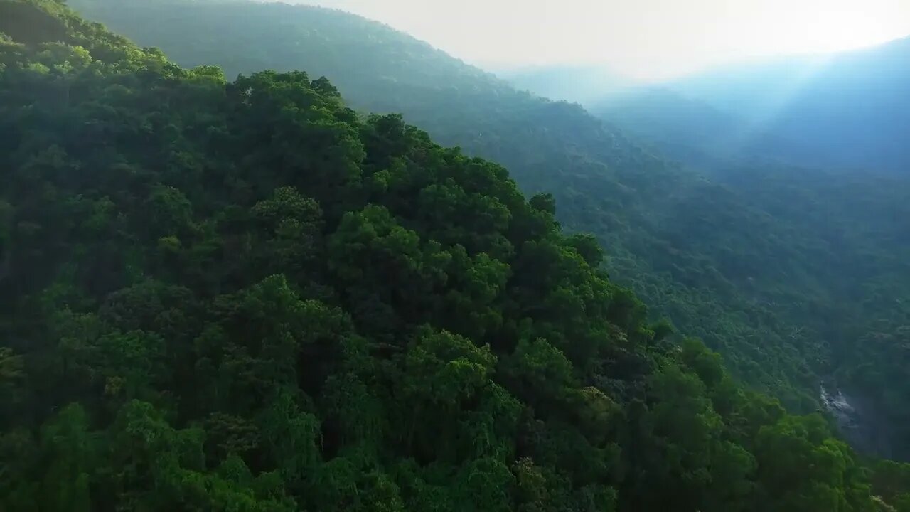 Light Rays Over Green Hillside