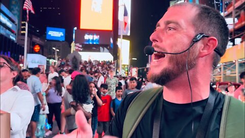 Many lock eyes and listen intently, nighttime preaching in Times Square