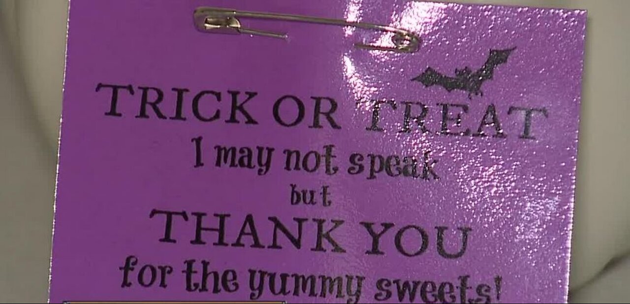 Teacher makes Halloween sign for non-verbal student