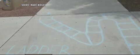 P.E. teachers draw chalk games for kids