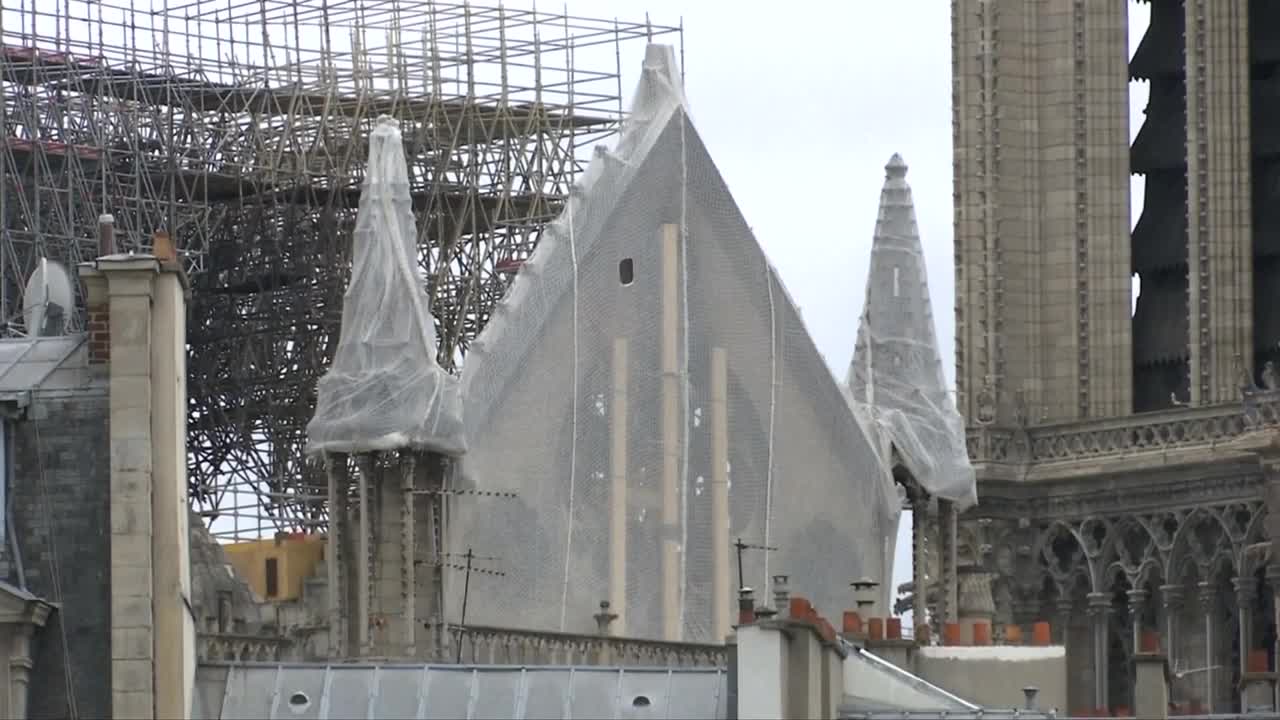 Workers install tarps to protect gutted Notre Dame from rain