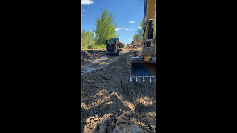 CAT 259D and 306cr excavating small pond