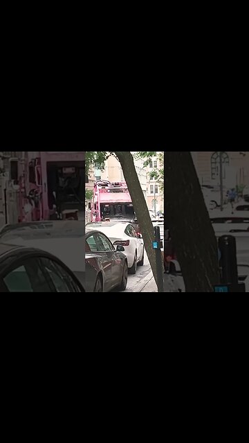 Garbage collector downtown busy road