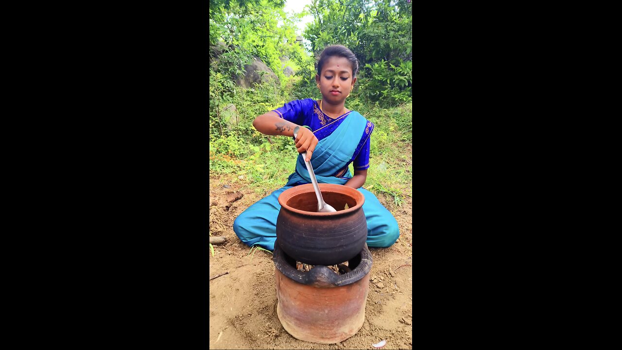 Beautiful village girl cooking meat