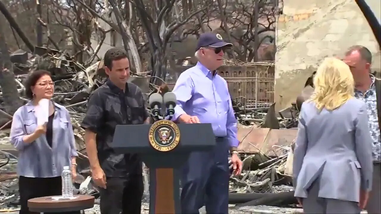 Senator Brian Schatz Asks Biden If He Wants A Sip Of Water Before Guiding Him From Podium