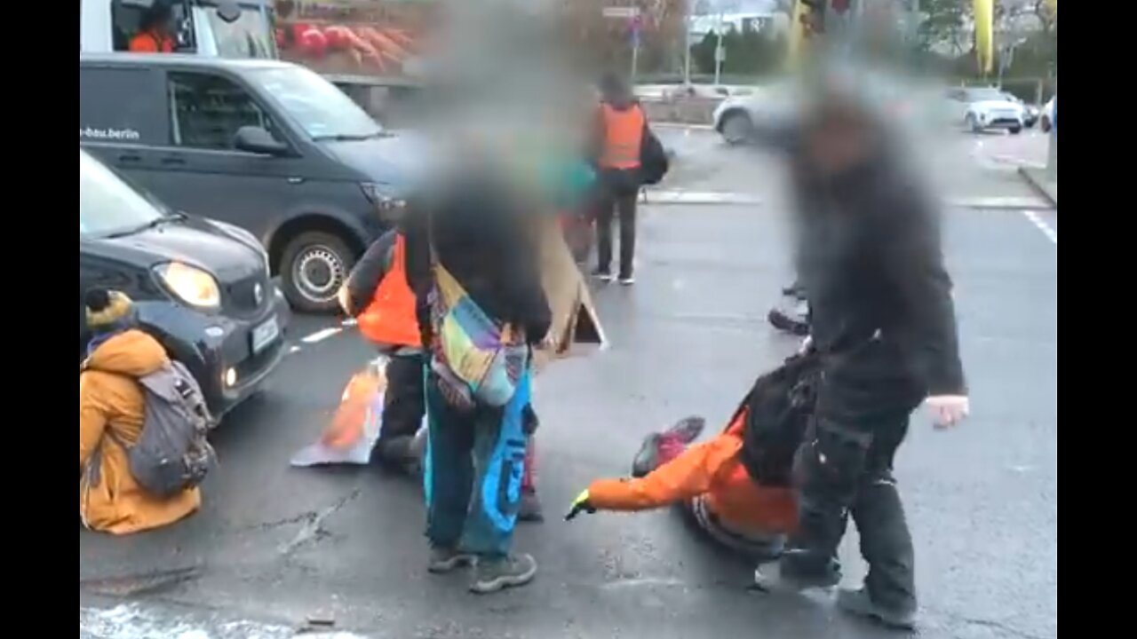 Kids from socialist movement get removed from their roadblock by citizens of Berlin, Germany 2022