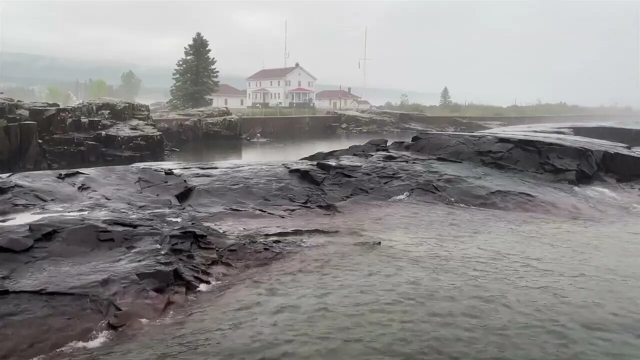 Rain over rocks at the US Coast Guard Station in Grand Marais by Lake Superior