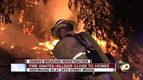 Fire ignites hillside close to homes