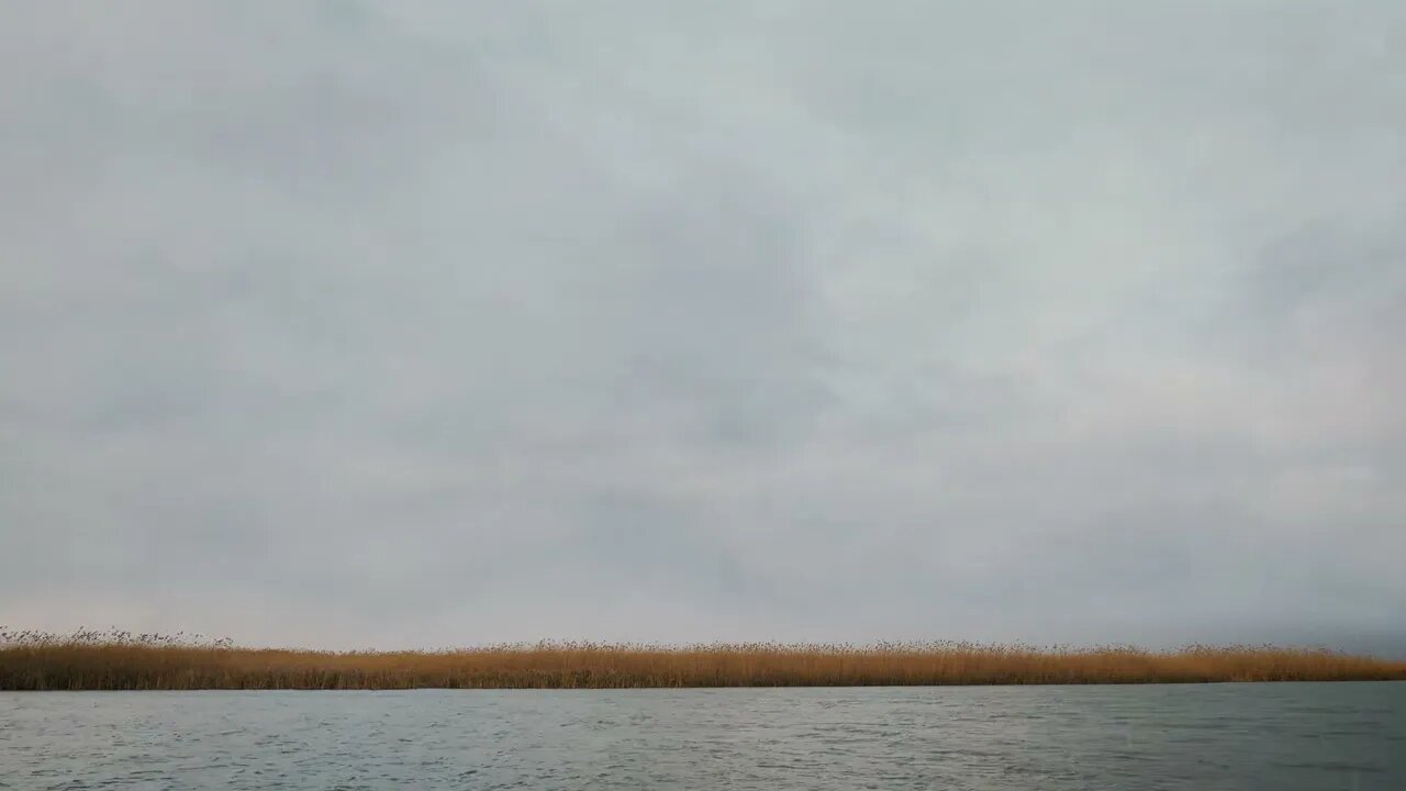 Rainfall over the waves on a fast flowing river.