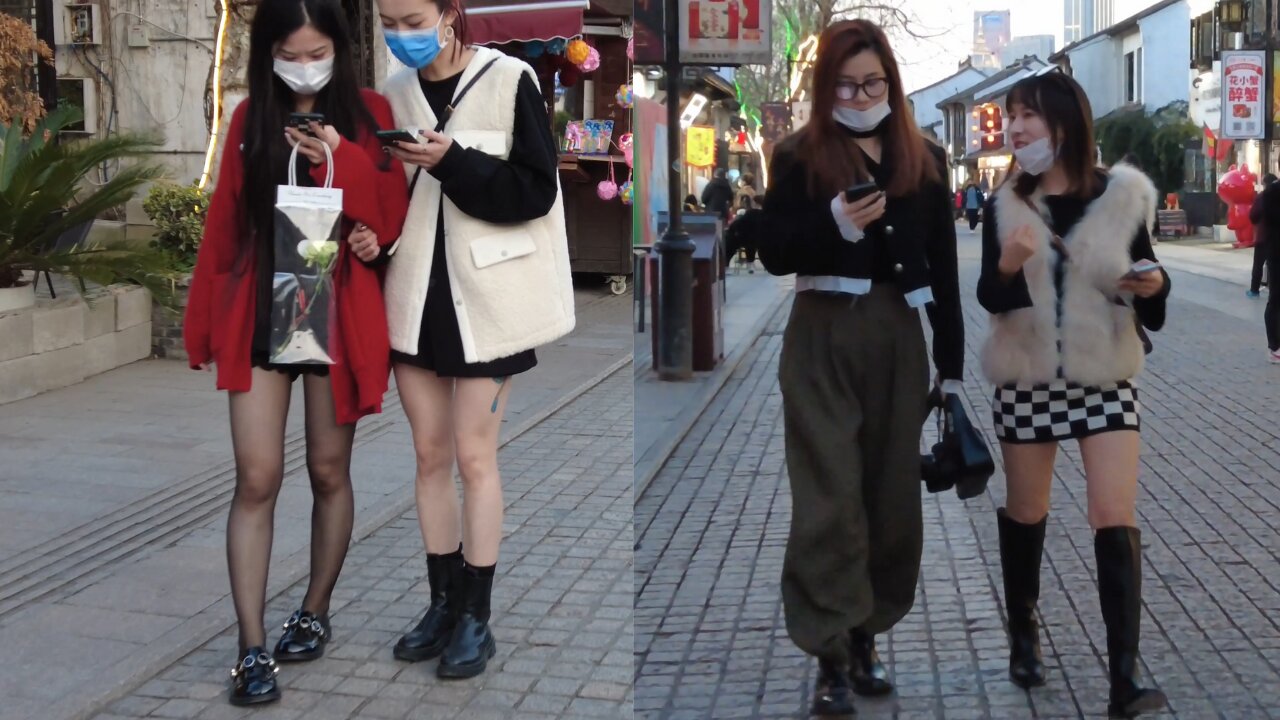 Beautiful legs in short skirts and black silk on the ancient street