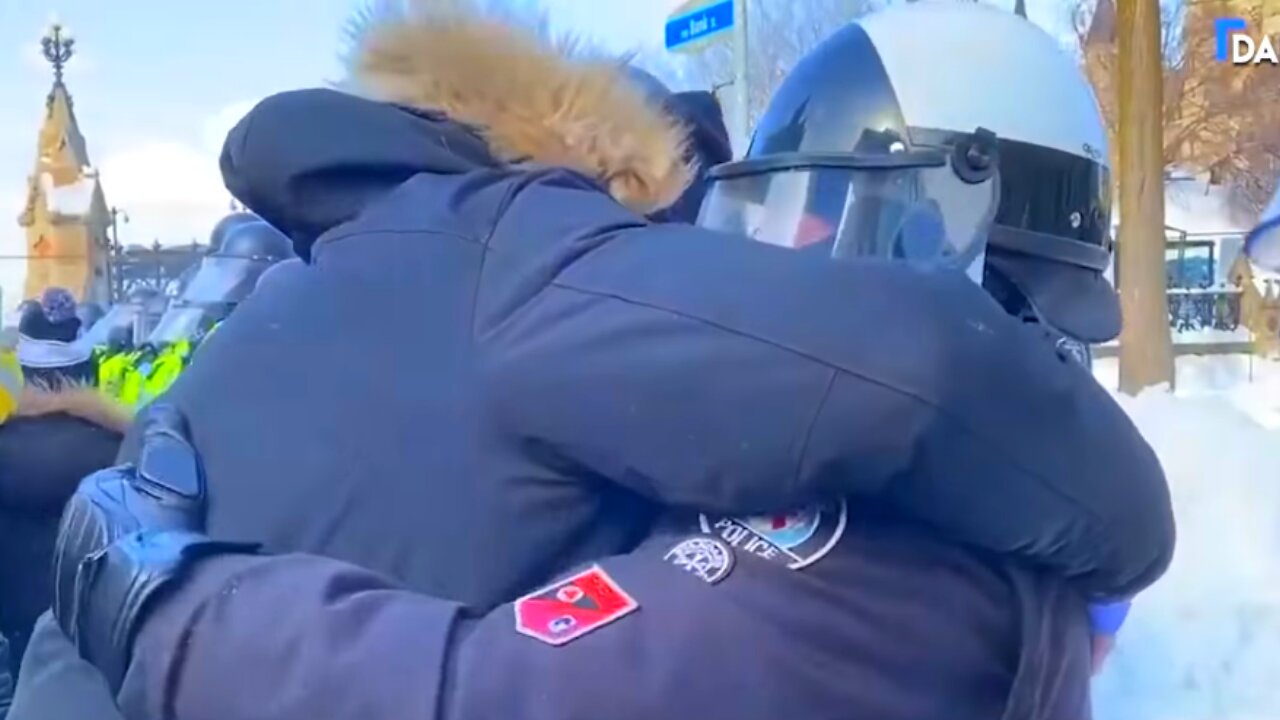 Toronto Police Officer Seen Hugging Protesters... Until He Seems To Be Told To Knock It Off