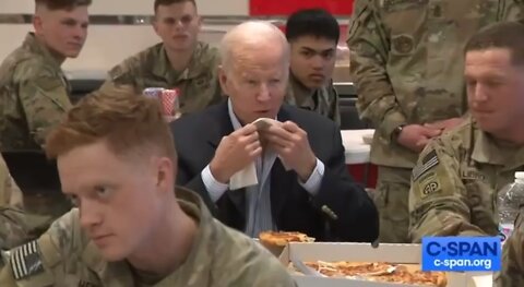 Clown Biden in Poland eating Pizza