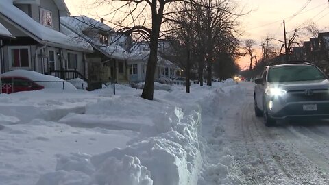 Snow remains in South Buffalo in the midst of a snow pick up pause due to a tragedy