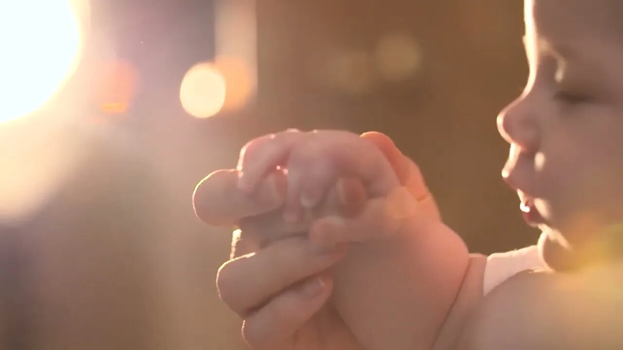 It seems that one of them is holding the finger of one of his parents.