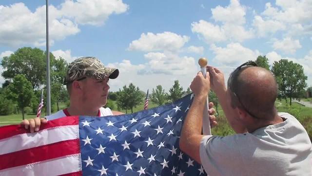 Raymore teens pull over to pick up fallen flag