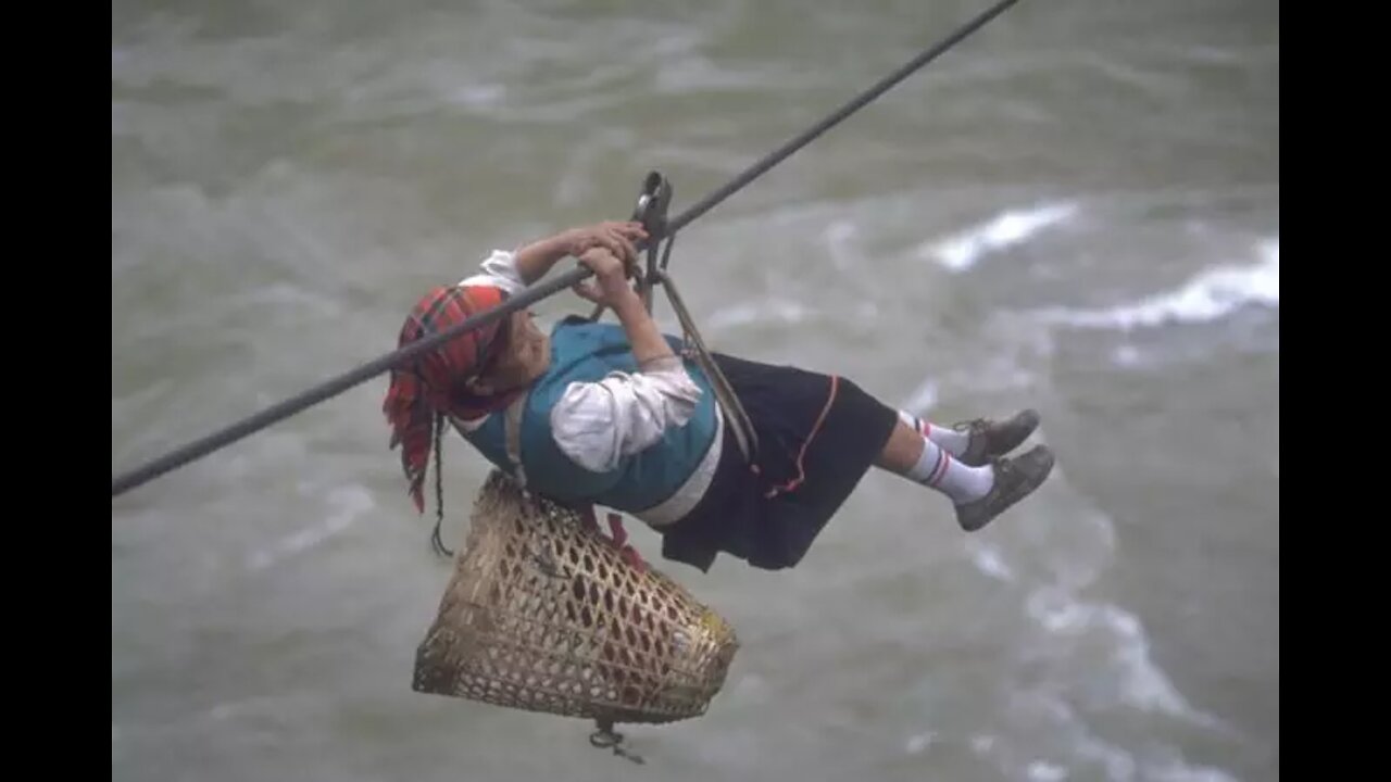 People crossing river with the help of rope
