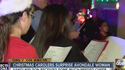 Woman surprised with Christmas carolers in Avondale