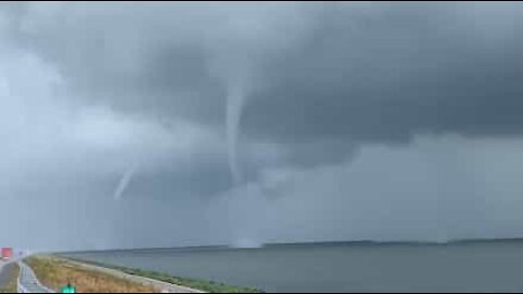 Driver captures footage of three simultaneous waterspouts