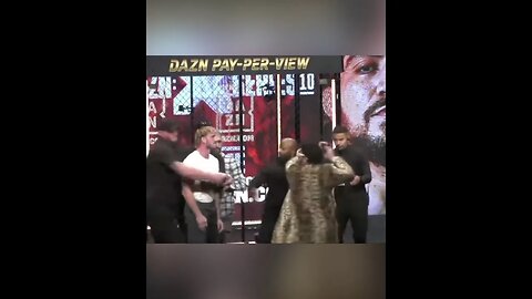 Ariel Helwani runs for cover as Dillon Danis hits Logan Paul with a microphone