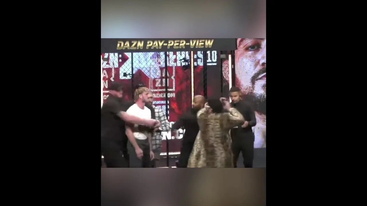 Ariel Helwani runs for cover as Dillon Danis hits Logan Paul with a microphone