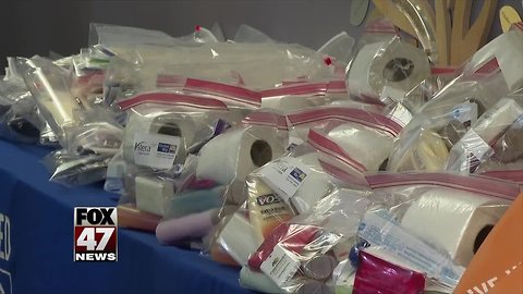 Employees make hygiene and budget kits for adults and kids
