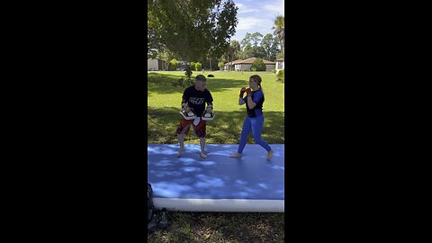 Little ninja practices Muay Thai roundhouse