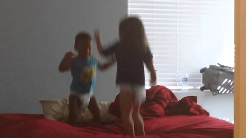 TJ and Tasha jump on the bed