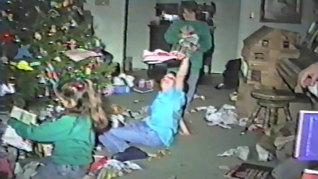 "A Young Boy Opens A Christmas Present And Goes Crazy"