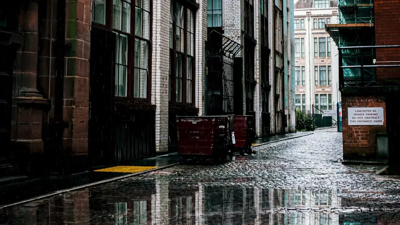 Rain over the cobblestoned back alley of Lancaster House in Manchester, England