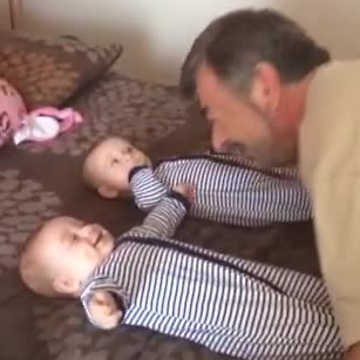 Grandpa makes twins laugh simultaneously