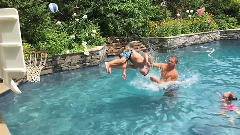 Young Boy Backflips And Shots A Basketball Into A Small Hoop