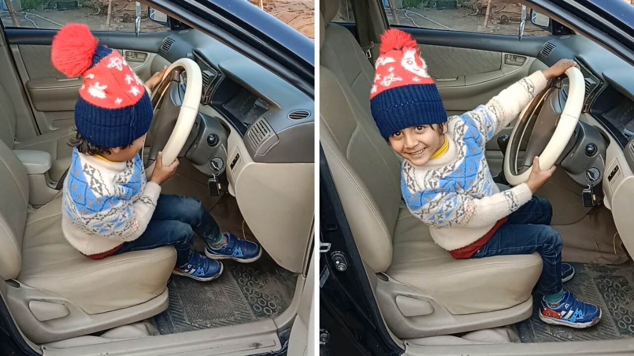 Toddler with a smiley tantrum trying to start the car