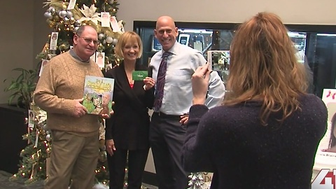 Gary Lezak gives Snowflake Contest winner prize