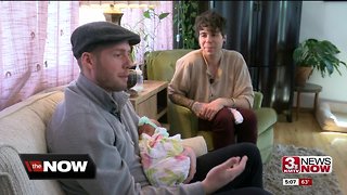 Grandma and Aunt help couple carry baby