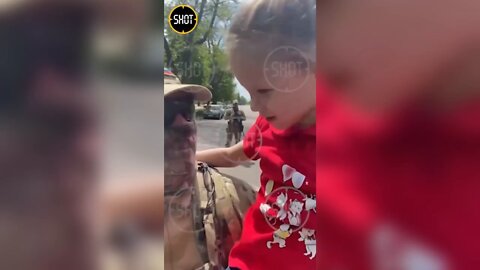 A conversation between a little girl and a soldier at a festival in Kherson