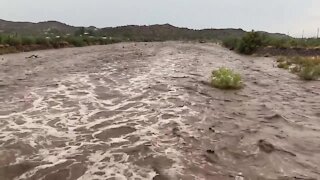 Flooding seen in the New River wash Friday afternoon