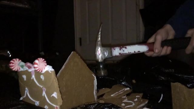 "A Boy Smashes A Gingerbread House With A Hammer"