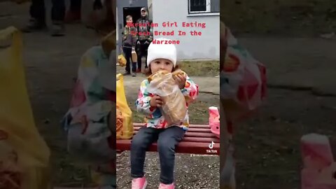 Ukrainian Girl Eating Bread From The Humanitarian Aid