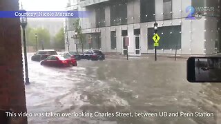 Drivers attempt to navigate through flooded areas on Charles Street