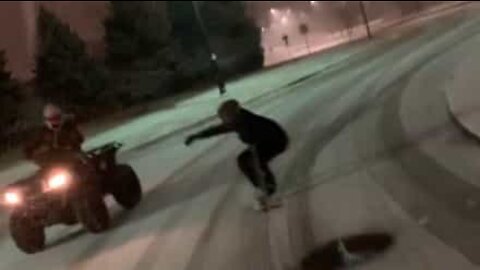 Nighttime snowboarding on the streets of Iowa