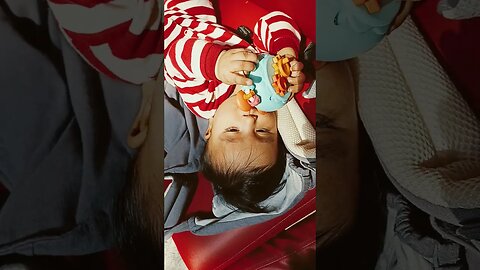 5 months old baby eating toys at the airport
