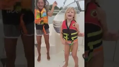 Kinzlee and Tasha dancing on the boat.