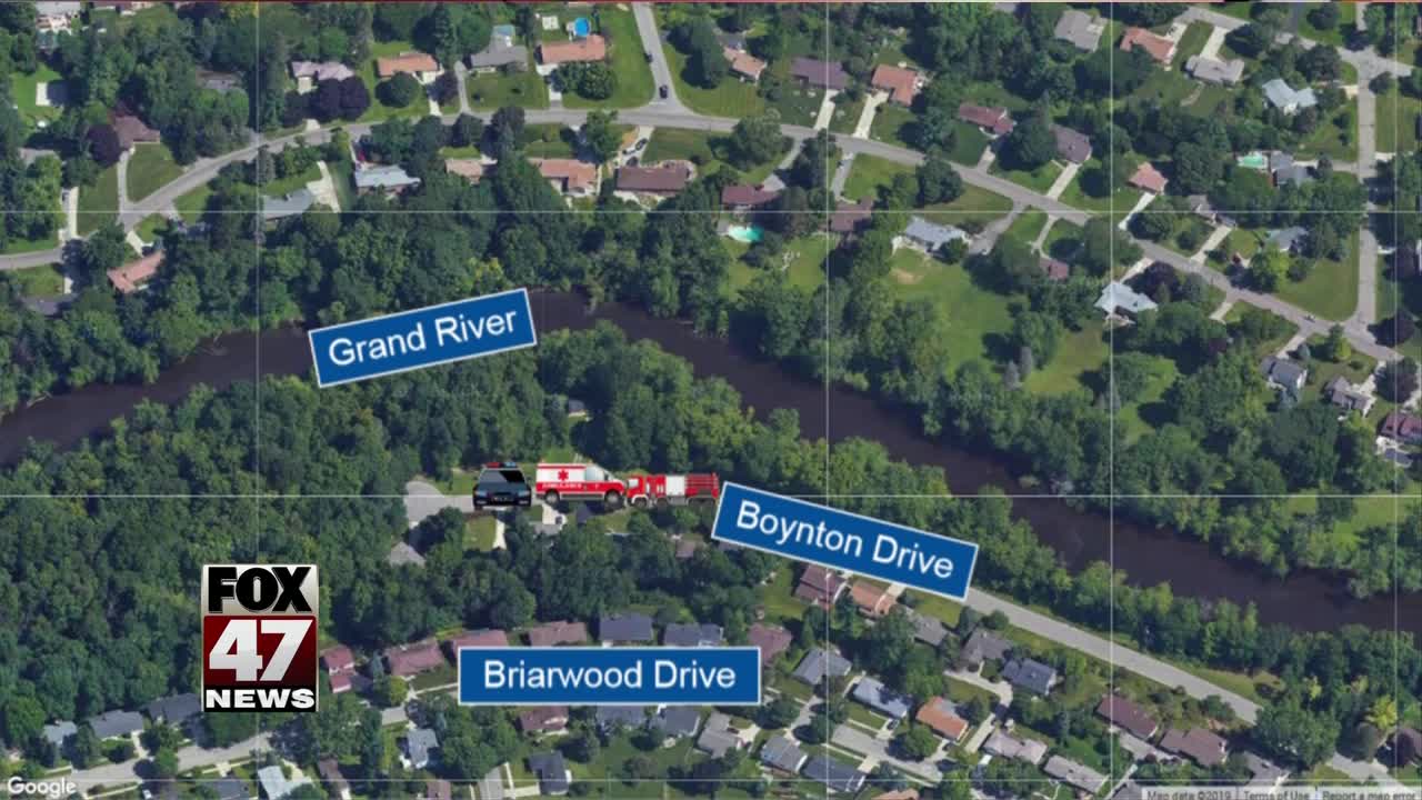 Woman saved after jumping into Grand River