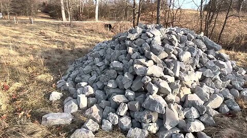 Deep ditch is getting a face lift with 12" rock.