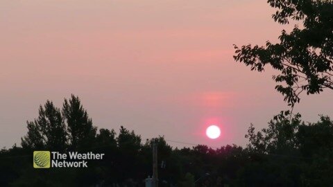 Sunrise casts pink and purple haze in the morning sky