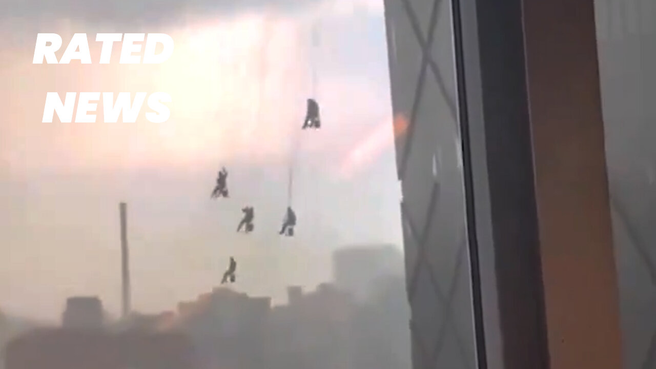 Window Cleaners Dangling from Beijing Tower During Storm